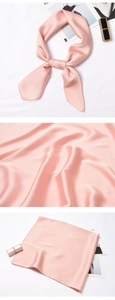 Detail showing smooth pink silk satin texture and versatile knots of the square neck scarf
