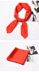 Detail of red silk satin square scarf showing smooth texture and bow knot styling