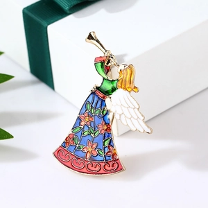 Cute enamel angel brooch with trumpet design in blue and gold on a gift box background