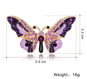 Detail view of purple enamel butterfly brooch with dimensions 5.9cm x 3.3cm and rhinestones
