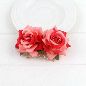 Detail of pink and red gradient rose hair comb with golden metal base and green leaves