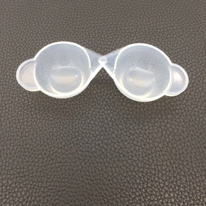 Close-up of translucent silicone mixing cups with pointed spouts for DIY resin pouring