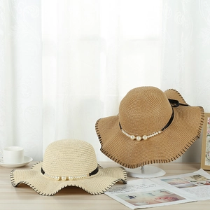 Elegant wide brim straw sun hats with pearl beads and black ribbons for summer beach