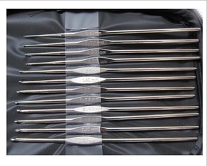 Close-up of 13 metal crochet hooks with etched size markings in a black fabric case