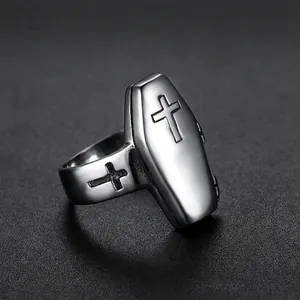 Gothic vintage stainless steel coffin ring with embossed cross detail on dark background