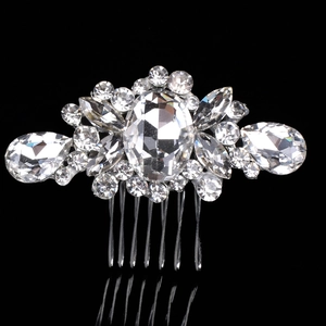 Close-up of silver bridal hair comb with faceted crystal rhinestones and six-tooth design