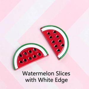 Macro detail of two resin watermelon slices with seeds for DIY jewelry making
