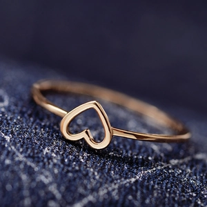 Minimalist rose gold hollow heart ring with slim band shown in a macro close-up view