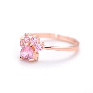 Detailed close-up of rose gold cat paw ring featuring pink heart-shaped zircon stones