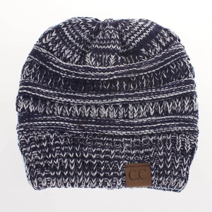 Detail of blue and white knit beanie featuring ribbed texture and brown leather C.C tag