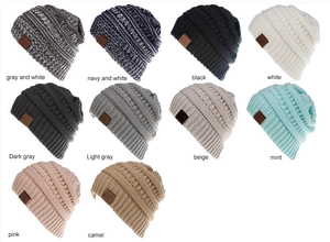 Flat lay display showing ten color options for thick cable knit beanies with CC labels