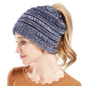 Detail view of winter cable knit ponytail beanie with functional opening for long hair