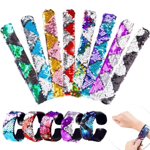 Detail of colorful reversible sequin slap bracelets showing multiple colors and textures