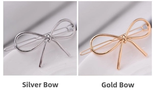 Detail view of bow-shaped metal hair clips in polished gold and silver finishes