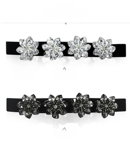 Detail of crystal flower elastic belt with rhinestones in black and white finish