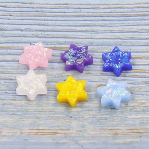 Close-up of star-shaped synthetic opal beads in various vibrant colors for DIY jewelry