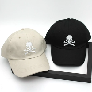Classic cotton baseball cap with embroidered skull and crossbones in black and beige
