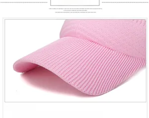 Detailed macro view of pink knitted visor with breathable mesh texture and sturdy brim