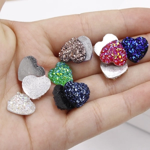 Detailweergave van 12mm hartvormige harsstenen met glittertextuur op de handpalm