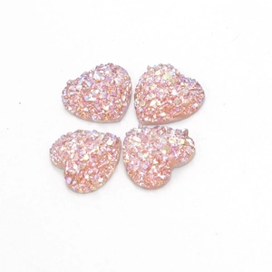 Gedetailleerde weergave van vier 12 mm roze hart-hars cabochons met sprankelende kristallen