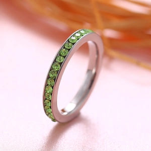 Silver stainless steel eternity ring featuring circular cut green birthstones in channel setting