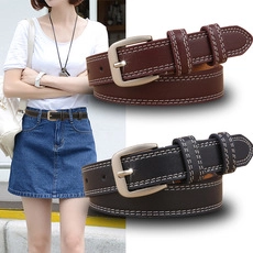 Detail view of crocodile pattern leather belts featuring white double stitching and metal buckles