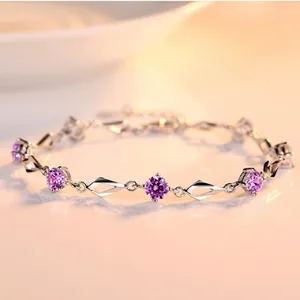 Elegant silver bracelet featuring geometric links and vibrant purple crystals details.