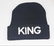 Detailed view of black knitted beanie featuring white KING embroidery on the folded cuff