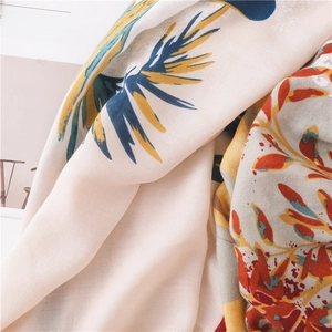 Detailed texture of cotton linen scarf with double-sided yellow and blue leaf patterns