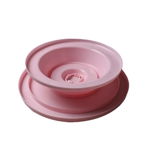 Detail view of pink PP plastic rotating cake turntable base with anti-slip concentric rings