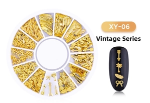 Retro golden nail art charm set with feather and tree shapes in a 12-grid wheel box