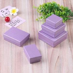 Elegant light purple linen texture jewelry gift boxes displayed on a wood background