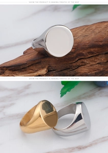 Macro detail of polished stainless steel signet rings in silver and gold tones