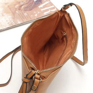 Brown leather crossbody envelope bag with adjustable strap and internal zipper pocket