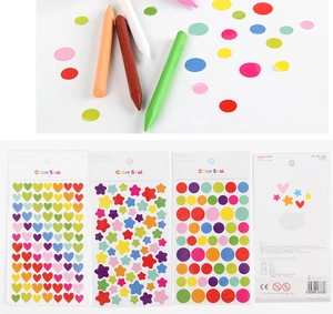 Detail showing colorful heart and star paper stickers with packaging and crayons
