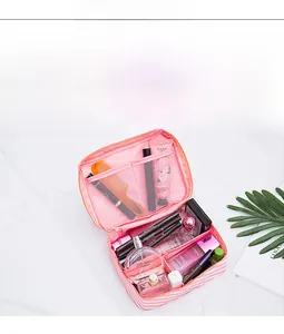 Detailed interior of a pink striped toiletry bag with mesh pockets and cosmetic organizer
