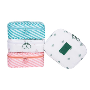 Set of four portable travel toiletry bags with flamingo, cactus, and striped patterns