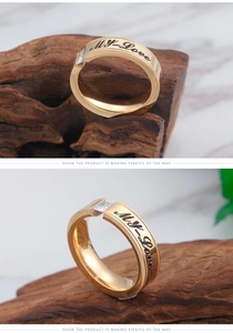 Detail of gold stainless steel ring with zircon stone and My Love engraving on band