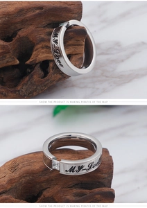 Macro detail of silver stainless steel ring with MY Love engraving and square zircon stone