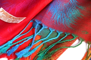 Close-up of ethnic jacquard scarf fringe and 100% Pashmina fabric material label