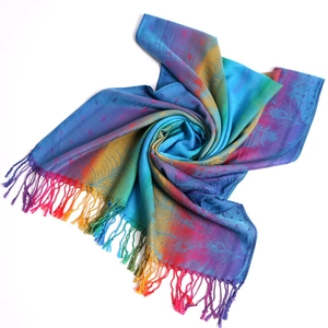 Detail of colorful jacquard scarf with peacock feather pattern and elegant tassels