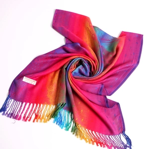 Macro detail of bohemian jacquard pashmina silk scarf with feather pattern and soft tassels