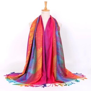 Detail of colorful peacock feather jacquard scarf with soft fringe tassels on a mannequin