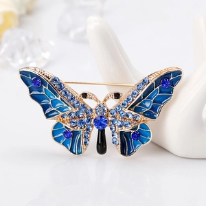 Elegant gold butterfly brooch with blue enamel wings and sparkling crystal rhinestones