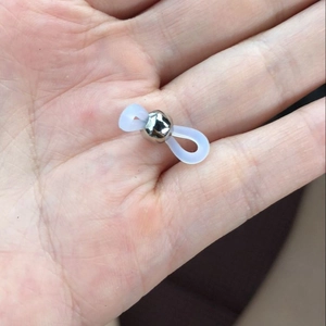 Adjustable silicone eyewear chain connector with silver bead held in hand