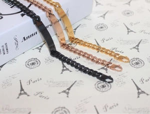 Men's titanium steel Cuban link bracelets in black, rose gold, and gold with nameplates