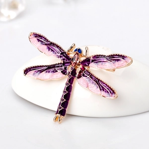 Fashionable enamel dragonfly brooch with purple wings and red gemstones in gold plating