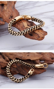 Detail of men's black leather and gold stainless steel braided bracelet with clasp