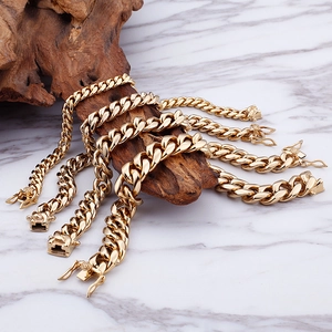 Golden Cuban link chains in various sizes displayed on natural wood with marble background
