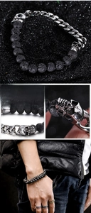 Detail of punk men's bracelet with black lava stone, steel chain and silver skulls